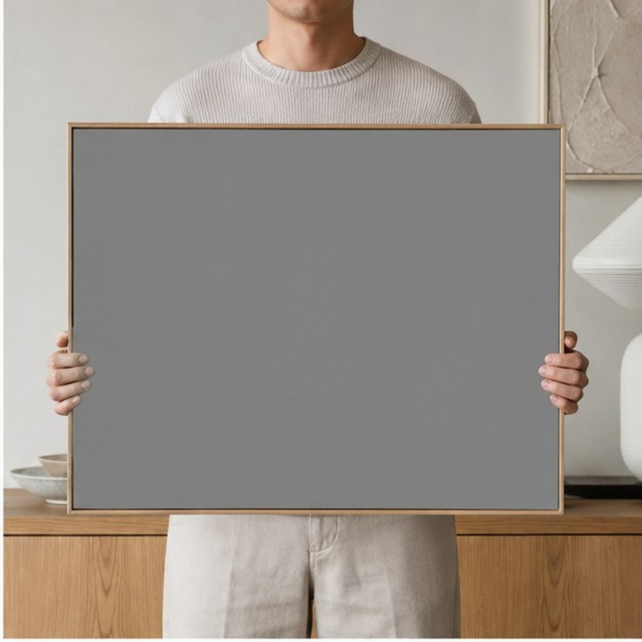 Collector holding a framed artwork
