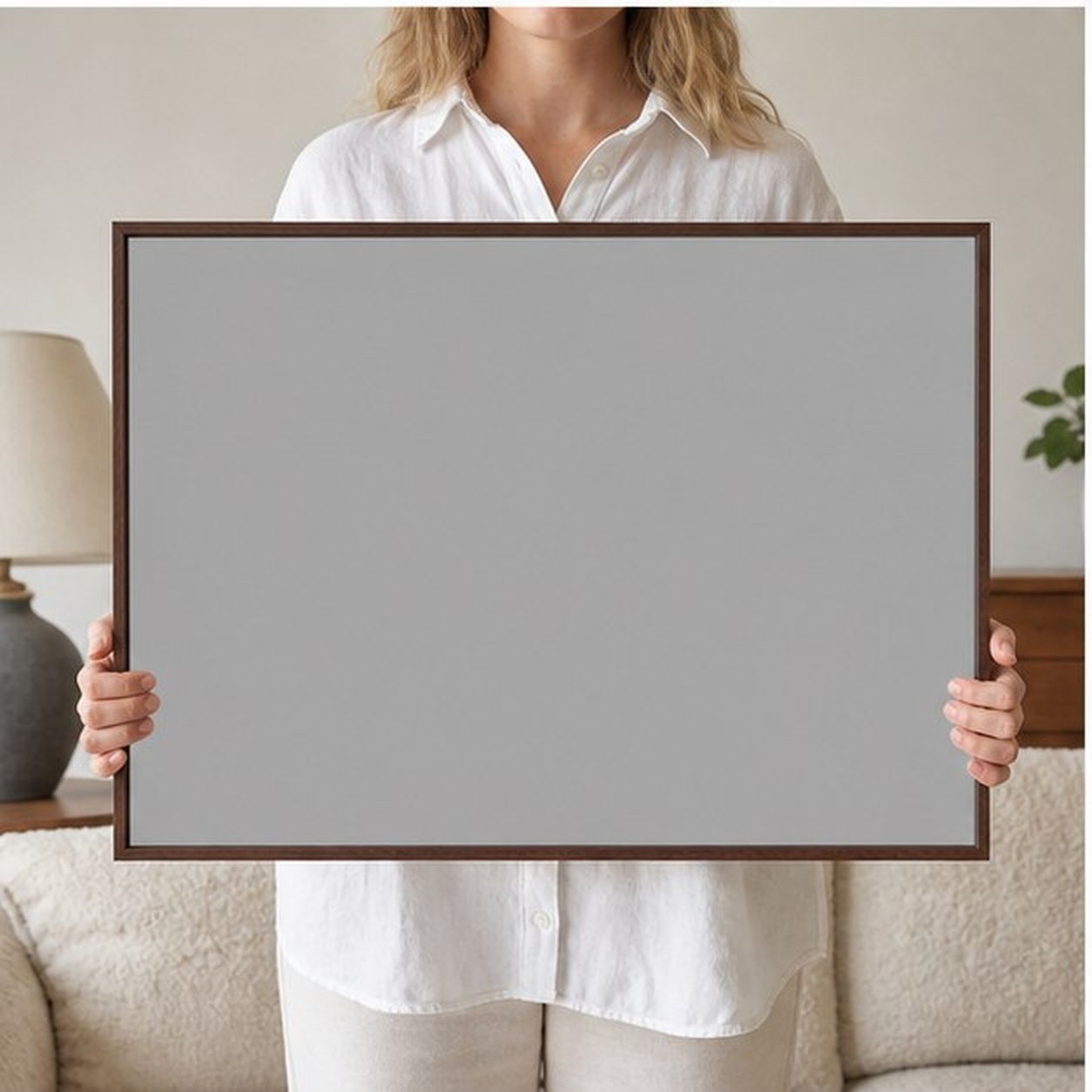 Collector holding a framed artwork