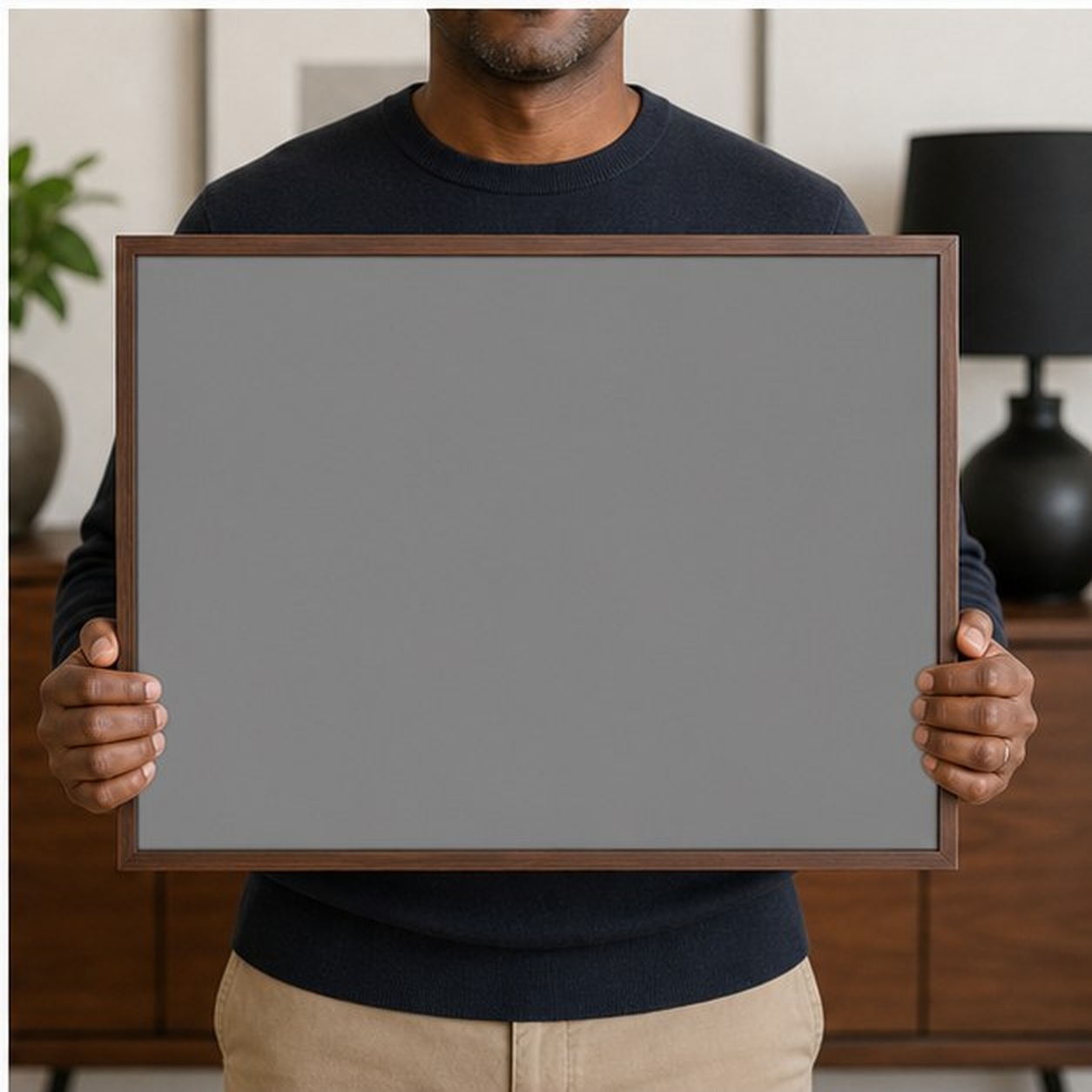 Collector holding a framed artwork