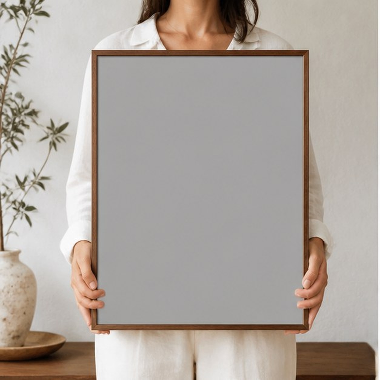 Collector holding a framed artwork